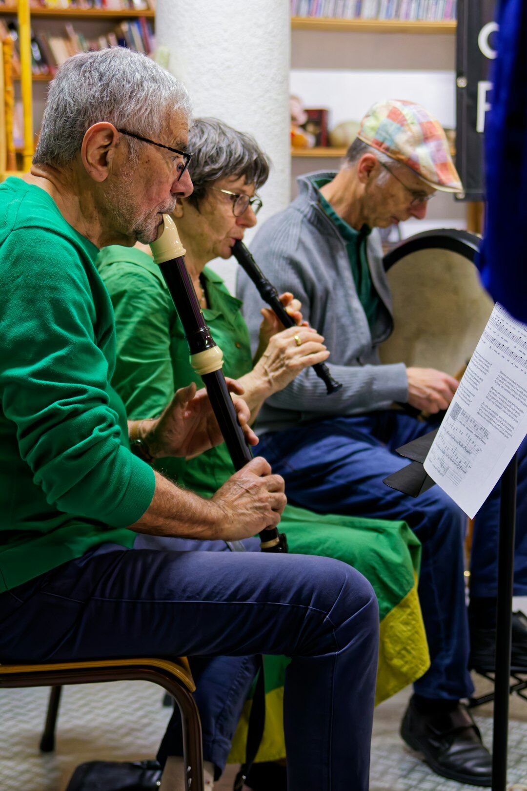 Group of seniors singing together holding songbooks