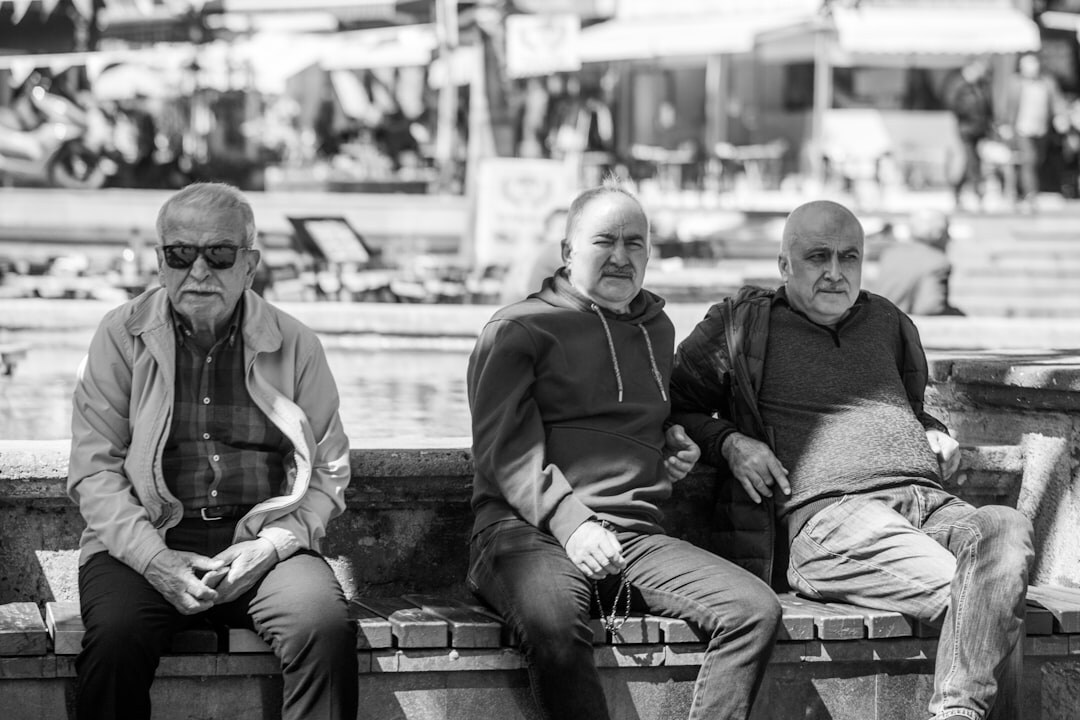 Group of laughing elderly friends spending time together outdoors